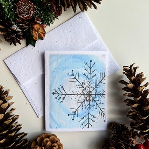 Enveloppe de carte de Noël plantable graines de fleurs sauvages, aquarelle bleue flocon de neige sur papier de graines de fleurs sauvages blanc, joyeux Noël