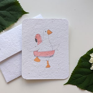 Oie dans la piscine flamant rose flottant sur papier à planter ou papier blanc aquarelle, bordures usées
