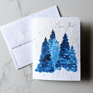 Enveloppe de carte à planter graines de fleurs sauvages, forêt de pins de Noël bleu sur papier de graines de fleurs sauvages blanc, joyeux Noël, carte de Noël