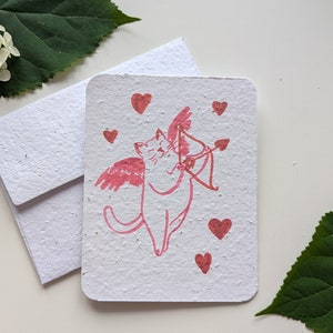 Cupidon chat avec coeur et noeud sur papier à planter ou papier blanc aquarelle, bordures usées