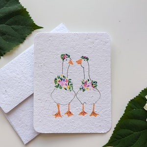 Mariage d'oies à l'autel sur une fleur sur papier à planter ou papier blanc aquarelle, bordures usées