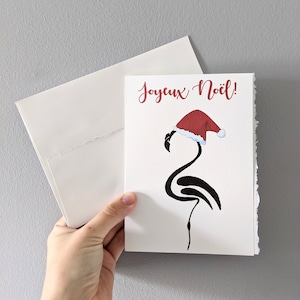Christmas card, minimalist flamingo in santa hat, black marker drawing flamingo merry christmas on white watercolor paper with worn borders