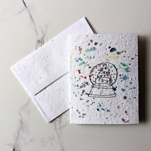 Arbre de Noël boule à neige sur papier de graines à planter ou papier blanc aquarelle, carte de Noël pour les fêtes