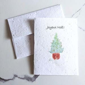 Sapin de Noël en pot sur du papier pour graines ou du papier blanc aquarelle, carte de Noël pour les fêtes