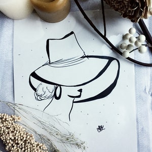 Black marker drawing of women with hat and hoops, decor, original poster art
