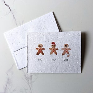 Biscuits de pain d'épice ho ho oh Chiens de vacances sur du papier de graines à planter ou du papier blanc aquarelle, carte de Noël de vacances