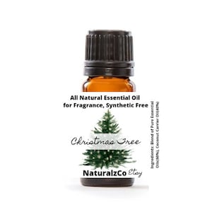 May include: A small amber glass bottle with a black cap, labeled "All Natural Essential Oil for Fragrance, Synthetic Free Christmas Tree NaturalzCo Etsy" and "Ingredients: Blend of Pure Essential Oils(60%), Coconut Carrier Oil(40%)".