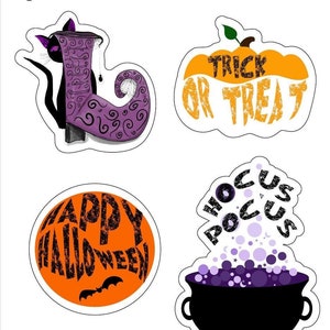 May include: Four Halloween themed stickers featuring a witch's boot with a black cat, a pumpkin with the text "Trick or Treat", a cauldron with purple potion and the text "Hocus Pocus", and a circle with the text "Happy Halloween".