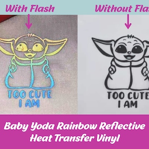 May include: A close-up of a Baby Yoda design on a light gray fabric. The design is made with rainbow reflective heat transfer vinyl. The image shows the design with and without flash. The text "TOO CUTE I AM" is below the design.
