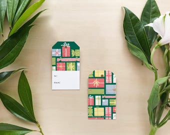 May include: Two gift tags with a green background and a pattern of colorful wrapped presents. The tags have white space for writing "To:" and "From:".