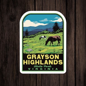 May include: A vintage-style sticker featuring a scenic view of Grayson Highlands State Park in Virginia. The sticker depicts a green grassy field with two horses grazing, a mountain range in the background, and a blue sky with white clouds. The text "GRAYSON HIGHLANDS State Park VIRGINIA" is printed in yellow and green on the sticker.
