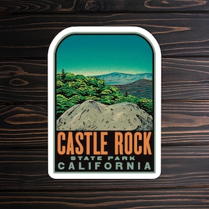 May include: A vintage-style sticker featuring a scenic view of Castle Rock State Park in California. The sticker has a blue sky, green trees, and a rocky hilltop. The text "CASTLE ROCK STATE PARK CALIFORNIA" is printed in orange and black.