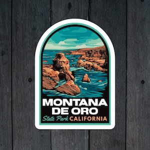 May include: A sticker with a scenic illustration of Montana de Oro State Park in California. The sticker features a blue sky, ocean waves crashing against rocky cliffs, and the text "Montana de Oro State Park California".
