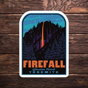 May include: A sticker featuring a scenic illustration of Yosemite's Firefall at Glacier Point. The design includes a waterfall with orange and red hues cascading down a dark mountain, set against a starry night sky. The text "FIREFALL" and "YOSEMITE" are also included.
