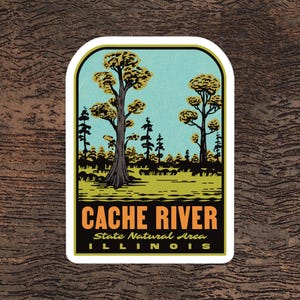 May include: A sticker featuring a stylized landscape with trees and the text "CACHE RIVER State Natural Area ILLINOIS." The design includes a light blue sky, green grass, and trees with yellow-gold foliage, all within a white-bordered rectangle.