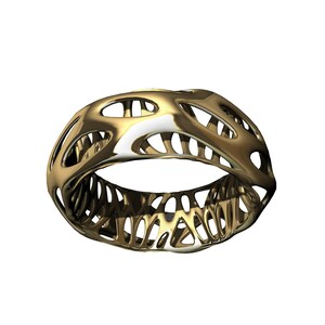 May include: A gold-colored ring with a geometric, openwork design. The ring is made of a smooth, shiny metal and has a delicate, intricate pattern.
