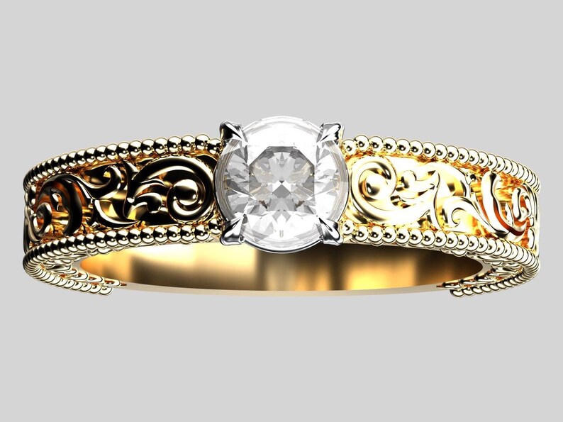 May include: A gold engagement ring with a large, clear, round-cut diamond. The band features intricate filigree and beaded detailing. The ring's design is ornate and elegant, showcasing a classic style.