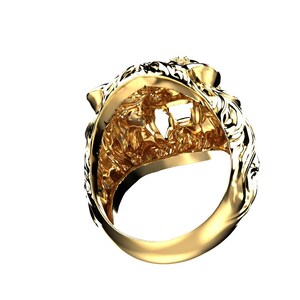 May include: A gold lion head ring with intricate details. The ring is made of solid gold and features a detailed lion head design.