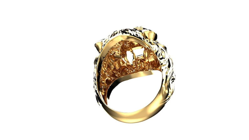 May include: A gold lion head ring with intricate details. The ring is made of solid gold and features a detailed lion head design.