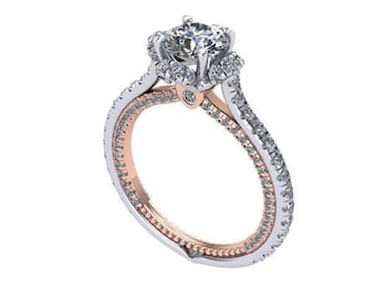 May include: A white gold and rose gold engagement ring with a large round diamond center stone and smaller diamonds set in a halo around the center stone. The band is set with smaller diamonds and has a rose gold accent.