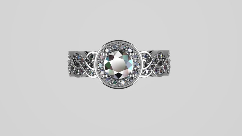 May include: A silver ring with a large, round, clear gemstone surrounded by smaller, clear gemstones. The band of the ring is intricately designed with a braided pattern.