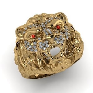 May include: A gold lion head ring with red eyes and a diamond-encrusted mane.