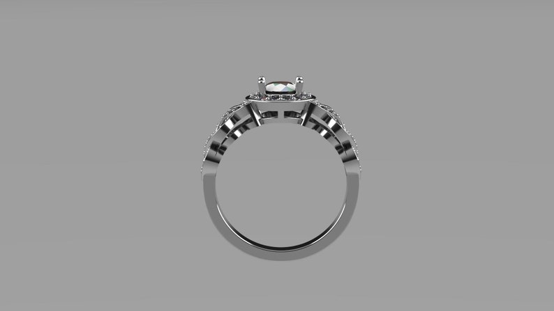 May include: A silver engagement ring with a large, clear center stone surrounded by smaller stones. The ring has a delicate, intricate design.