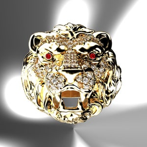 May include: A gold lion head ring with red ruby eyes and a diamond-encrusted design.