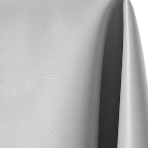 May include: A light gray fabric with a smooth, leather-like texture and a subtle sheen. The material is draped to create soft, vertical folds, highlighting the consistent matte finish and the fine, pebbled grain pattern across the surface.