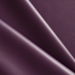 May include: Close-up of a deep purple faux leather fabric with a textured surface. The fabric is folded in a way that shows the texture and sheen.