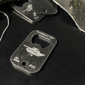 Token Keychain Bottle Opener of Russian combat tank made of burned amor t 90 from Ukraine, two in one keychain and bottle opener, piece tank