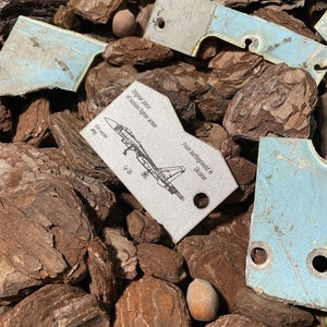 Token of Russian combat airplane made of burned armor Cy 35 recycled in Ukraine