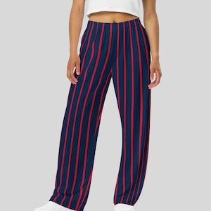 May include: Navy blue and red striped palazzo pants. The pants feature vertical red stripes against a navy blue background. The wide-leg design and elastic waistband offer a comfortable fit. The pants are made of a soft, flowing fabric.