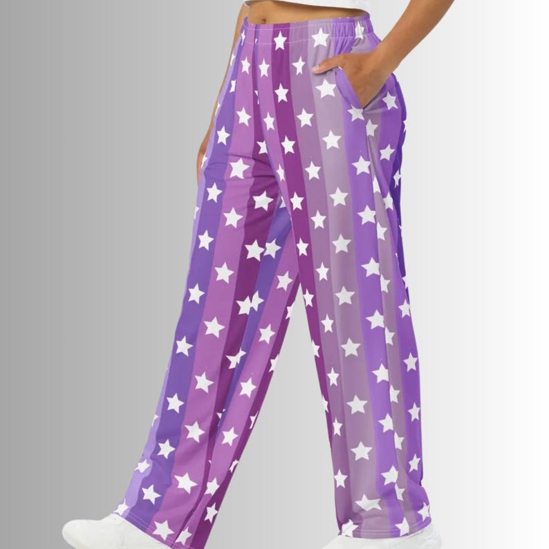 Puede incluir: Pantalones de pijama morados y blancos con estampado de estrellas. Los pantalones presentan rayas verticales de diferentes tonos de morado, adornadas con estrellas blancas. El dise&ntilde;o de pierna ancha incluye bolsillos. El modelo lleva zapatos blancos.