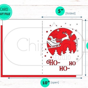 May include: A red and white Christmas card with a Santa Claus and reindeer flying through the air. The card is 5 inches by 7 inches when folded and 10 inches by 7 inches when open. The card has the words "HO HO HO" printed on it.