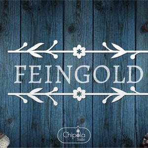 May include: White text that reads "FEINGOLD" with a floral design above and below the text. The design features white flowers and leaves on a blue wood background.