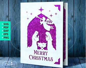 May include: A white paper Christmas card with a purple glitter background. The card features a silhouette of the nativity scene with Mary, Joseph, and the baby Jesus in a manger. An angel is above them with a trumpet. The text "Merry Christmas" is at the bottom of the card.