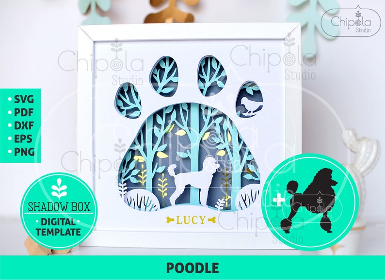 May include: A white framed shadow box featuring a poodle silhouette within a paw print design. The layered paper art includes trees and the name "LUCY". Additional graphics include a poodle silhouette and the word "POODLE".