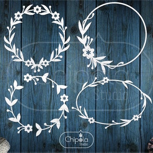 May include: Four white floral wreaths with a woodgrain background. The wreaths are in different shapes and sizes, including a circle, oval, and a half-circle. The wreaths are made of leaves and flowers.