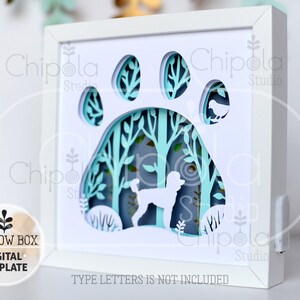 May include: A white shadow box with a paw print design. The paw print reveals a layered forest scene with a poodle silhouette. The design includes the text "SHADOW BOX DIGITAL TEMPLATE". The text "TYPE LETTERS IS NOT INCLUDED" is also visible.