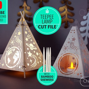 May include: A digital cut file for a teepee lamp with a celestial design. The design features stars, a planet, and a wavy line. The teepee is made of wood and has a small window. The file includes instructions for assembly and comes with bamboo skewers.