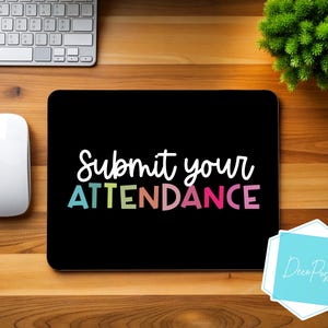 May include: Black laptop screen with the text "Submit your ATTENDANCE" in rainbow colours. The text is on a black background. The laptop is on a wooden surface.