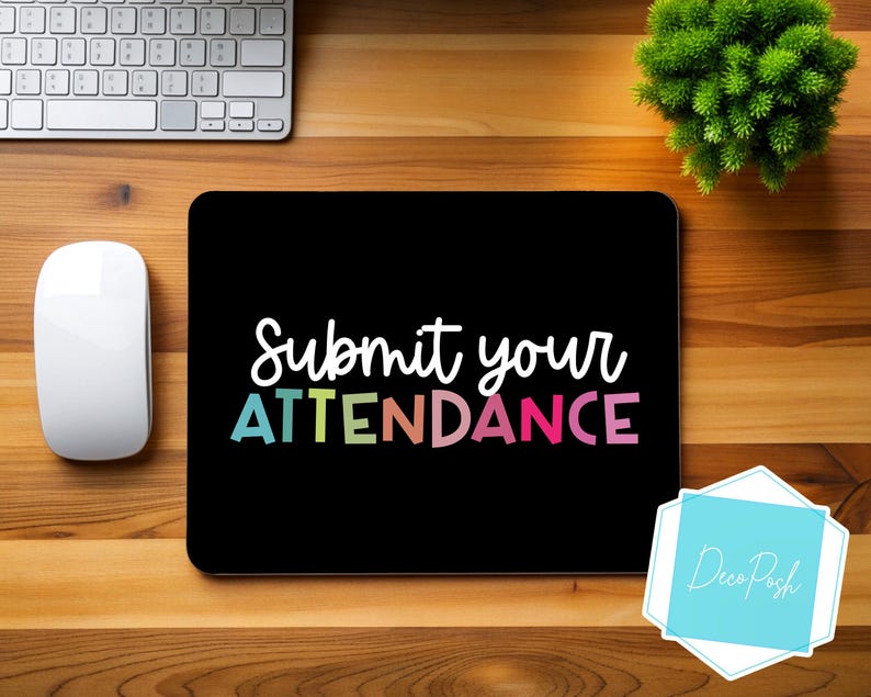 May include: Black laptop screen with the text "Submit your ATTENDANCE" in rainbow colours. The text is on a black background. The laptop is on a wooden surface.