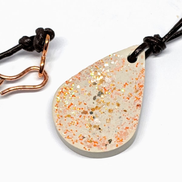 Handcrafted Concrete Pendant Necklace, Teardrop Shaped with Coral & Gold tone Inclusions on Brown Leather Cord