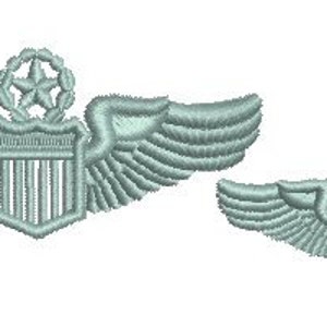 May include: Two embroidered silver-colored pilot wings with a shield and star in the center. The larger wings are on the left and the smaller wings are on the right.