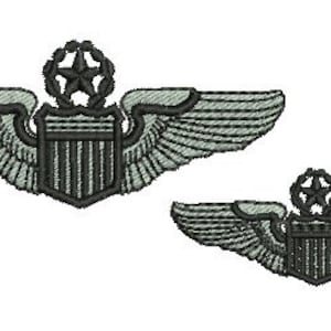 May include: Two embroidered military pilot wings with a shield and star design. The larger wings are gray with black details, and the smaller wings are black with gray details.