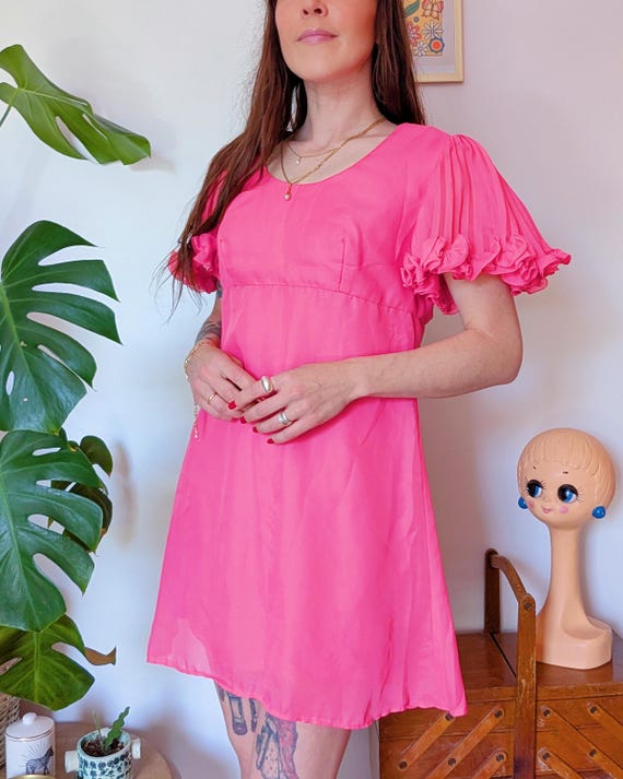 twiggy pink dress 1966, A portrait of model Twiggy wearing a fashionable pink dress and... News Photo