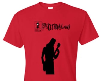 May include: Red t-shirt with a black silhouette of a person playing a guitar and the text "Bucketheadland" with the number "1228134".