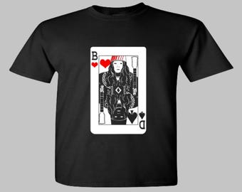 May include: Black t-shirt with a white graphic of a playing card. The card is the Queen of Diamonds and features a woman with a red and white striped hat and a black and white outfit.