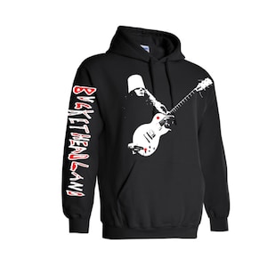 May include: Black hooded sweatshirt with a white graphic of a person wearing a bucket hat and playing a guitar. The text "BUCKETHEADLAND" is printed in white and red on the sleeve.
